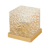 Textured glass cube lamp with gold base, modern geometric design, ambient lighting