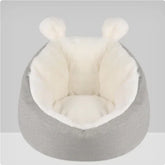 Plush gray and white faux fur lounge chair with rounded back and ear-shaped accents, cozy fit