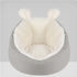 Plush gray and white faux fur lounge chair with rounded back and ear-shaped accents, cozy fit