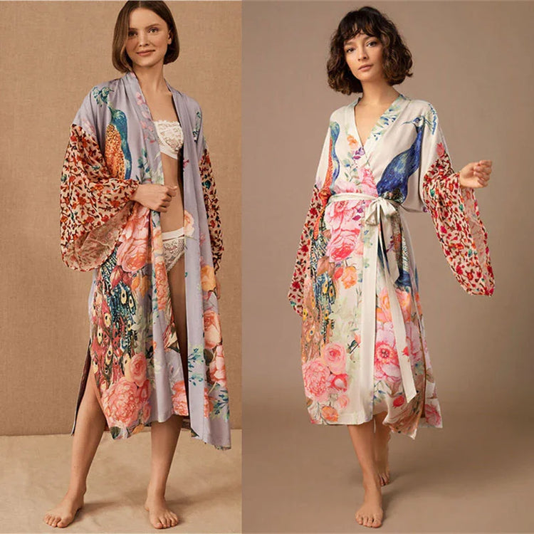 Women wearing long floral satin kimono robes with wide sleeves, relaxed fit, and pastel prints