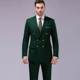 Man wearing a slim fit double-breasted dark green suit with gold buttons, white shirt, and tie