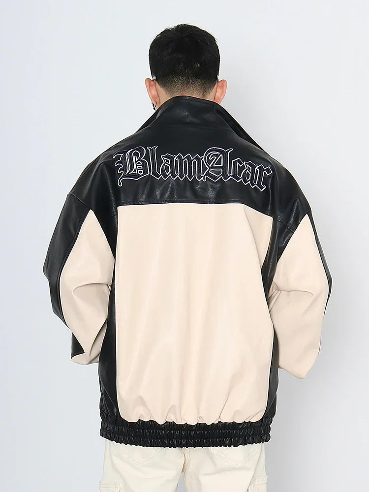 Man wearing oversized two-tone black and beige faux leather streetwear jacket with graphic back.