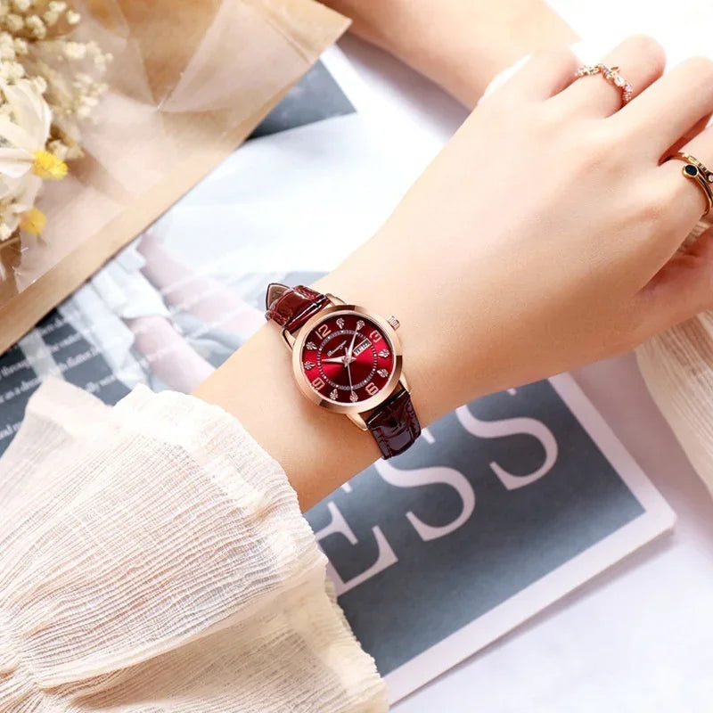 Woman wearing a red leather strap watch with a glossy red dial and gold case