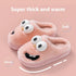 Plush pink fuzzy slippers with cartoon eyes and smiling face, thick warm cozy fit.