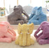 Plush elephant toys in yellow, pink, purple, gray, and blue, soft fabric, cozy decor.