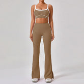 Woman wearing brown fitted two-piece athleisure set with white trim and flared pants