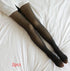 Sheer black tights with a slim fit, worn on legs and styled on a white bedding background