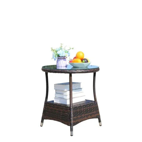 Round wicker side table with glass top, books, fruit bowl, and flower vase display