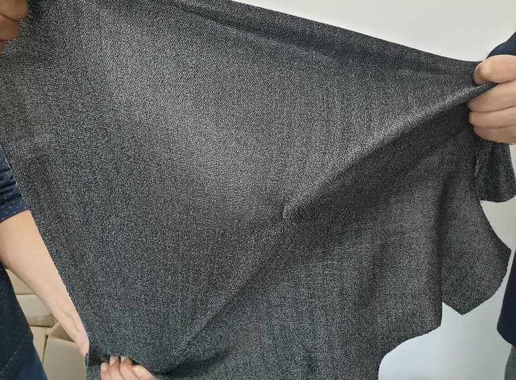 Grey Level 5 cut resistant lightweight long sleeve shirt fabric being stretched