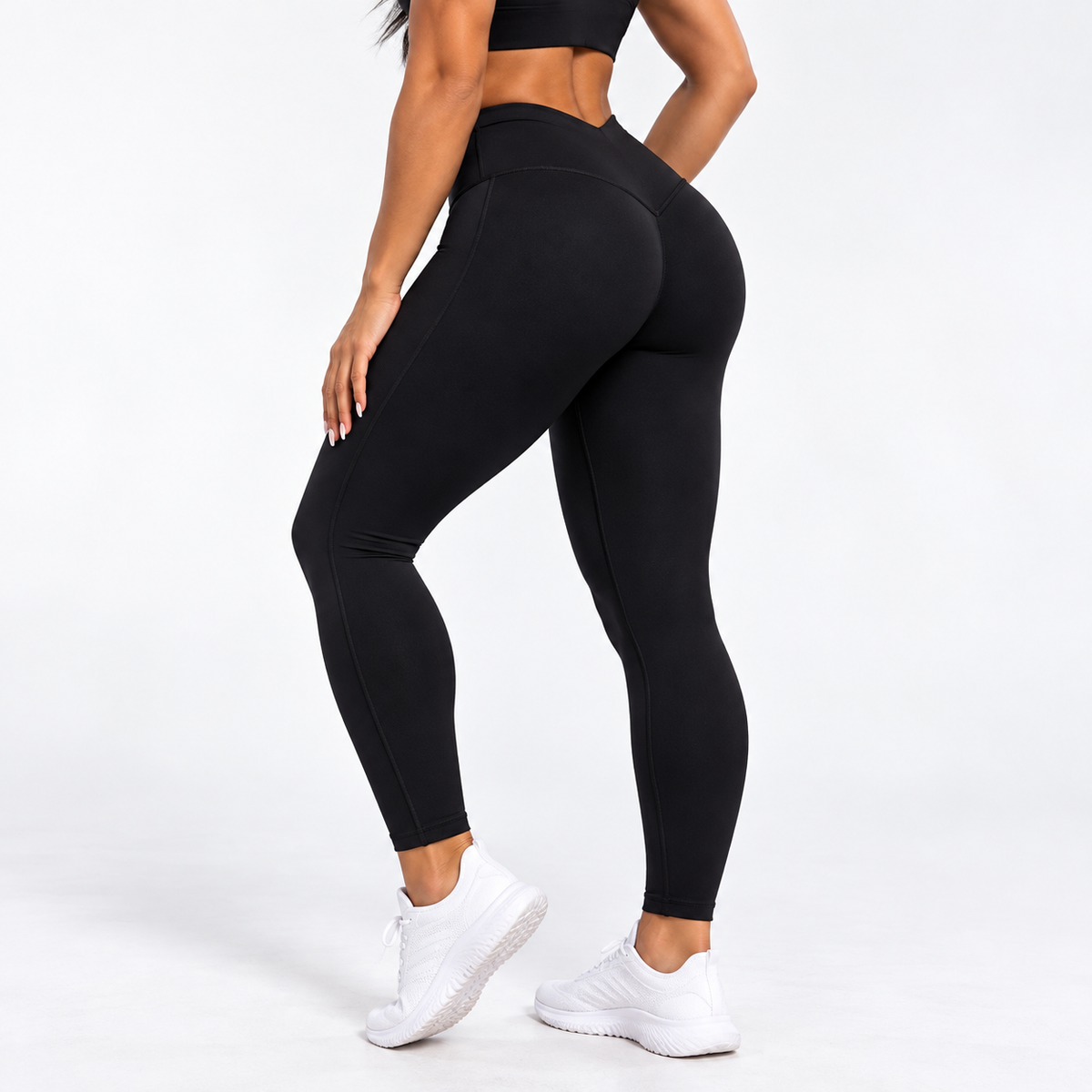 Close-up of women's high-waist black leggings with supportive fit, worn during gym training, white sneakers, SKU: TR-10740