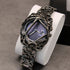 Futuristic streetwear watch with metallic skeleton frame, purple dial, and intricate chain strap
