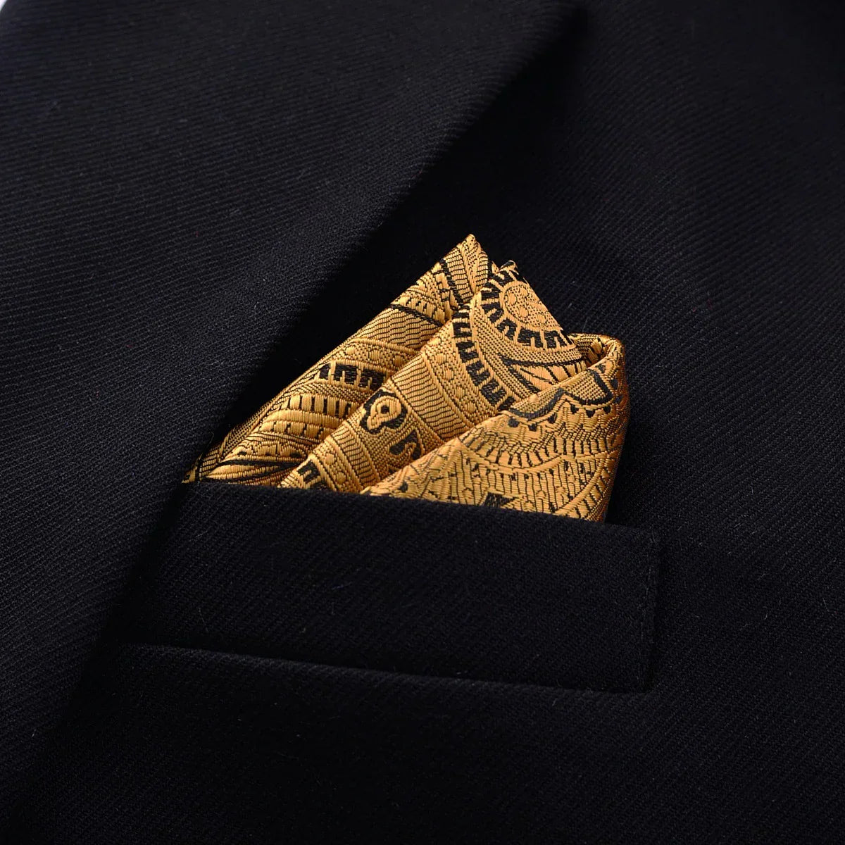 Black blazer with a gold patterned silk pocket square in the breast pocket