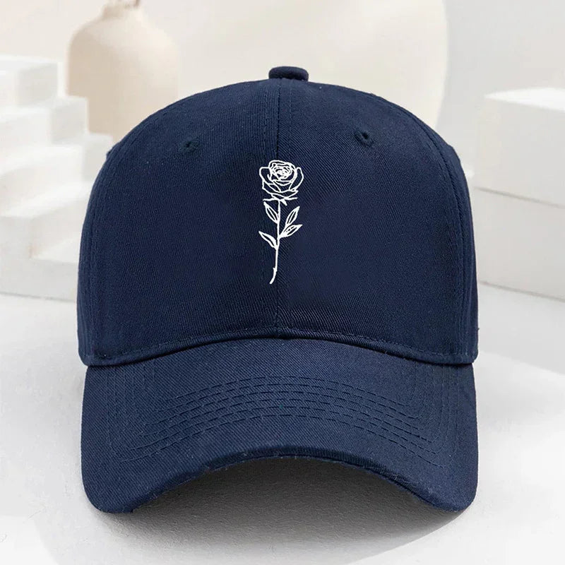 Navy blue cotton baseball cap with embroidered white rose design, adjustable fit