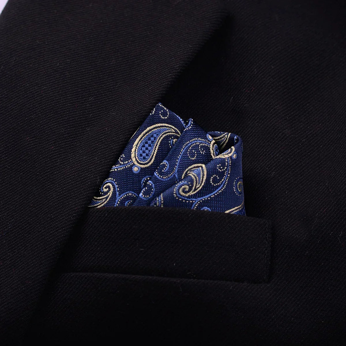 Navy blue paisley silk pocket square in black blazer chest pocket, formal style