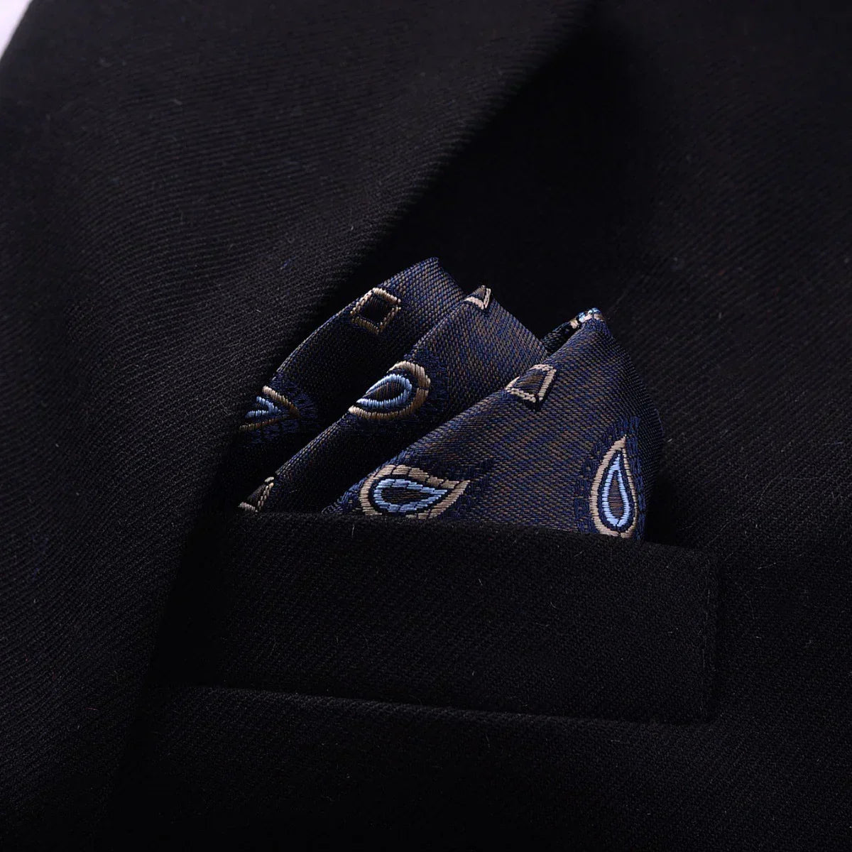 Black suit jacket with a blue paisley silk pocket square, modern formal style