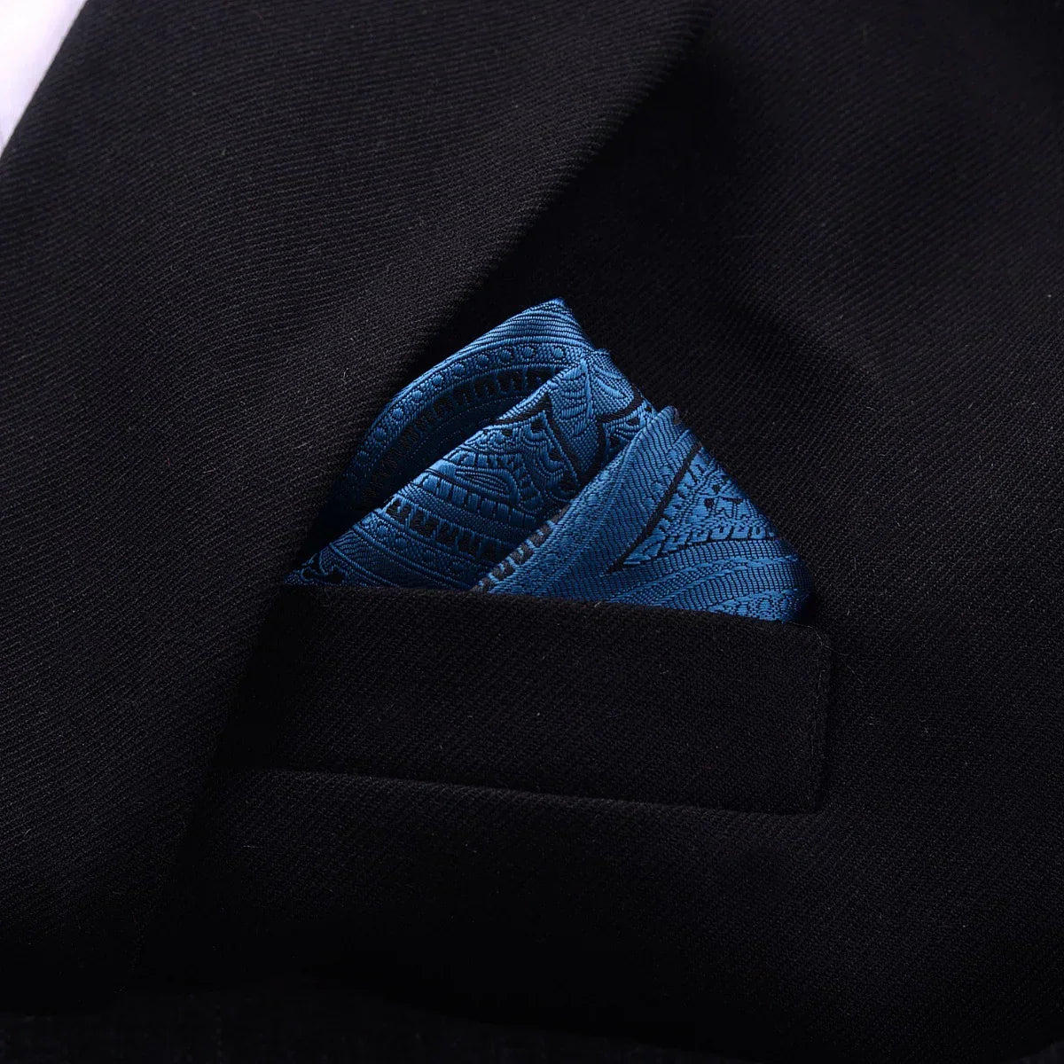 Black blazer with blue patterned silk pocket square, formal menswear accessory