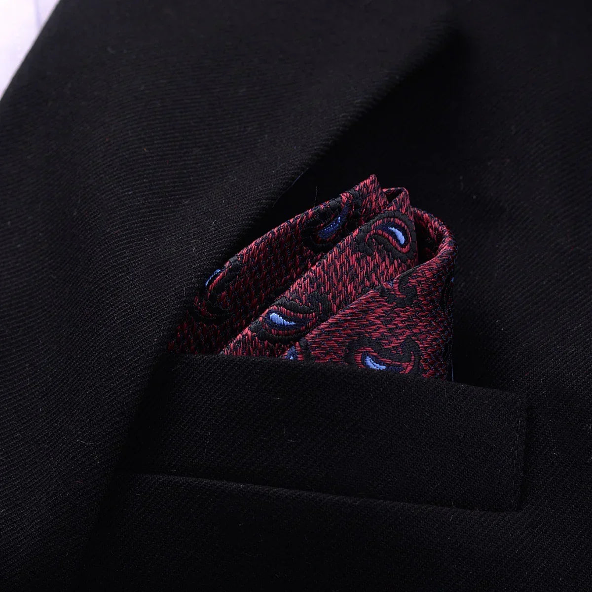 Classic black blazer with a red patterned silk pocket square in the chest pocket