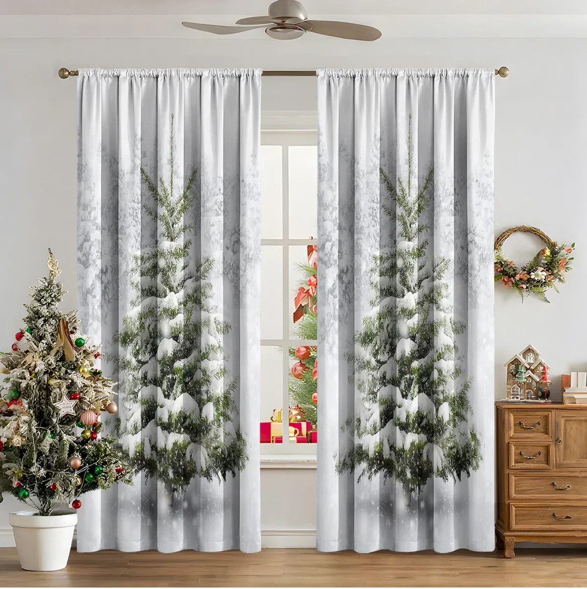 White curtains with snowy pine tree print, Christmas tree and festive decor in living room