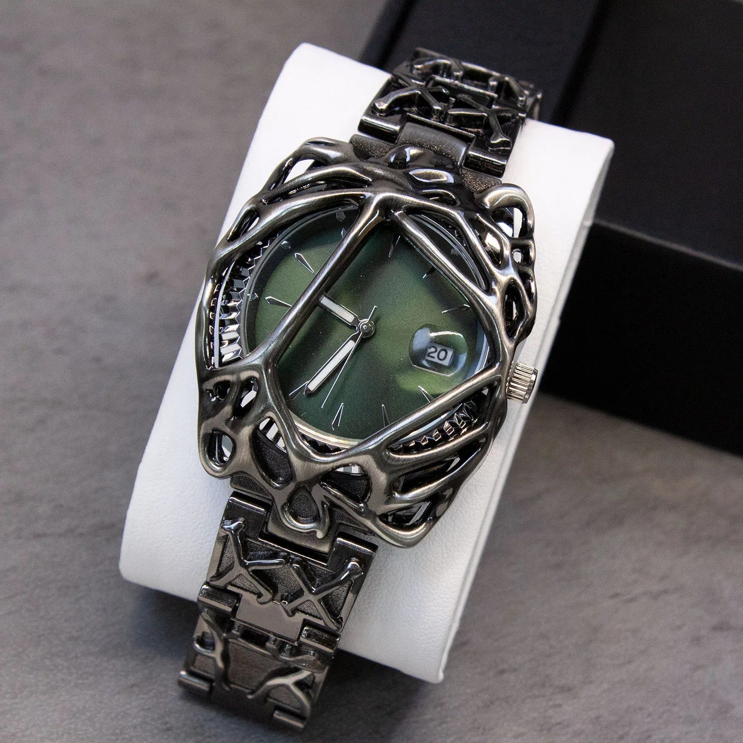 Futuristic black metal watch with green dial and skeletonized geometric bracelet