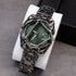 Futuristic black metal watch with green dial and skeletonized geometric bracelet