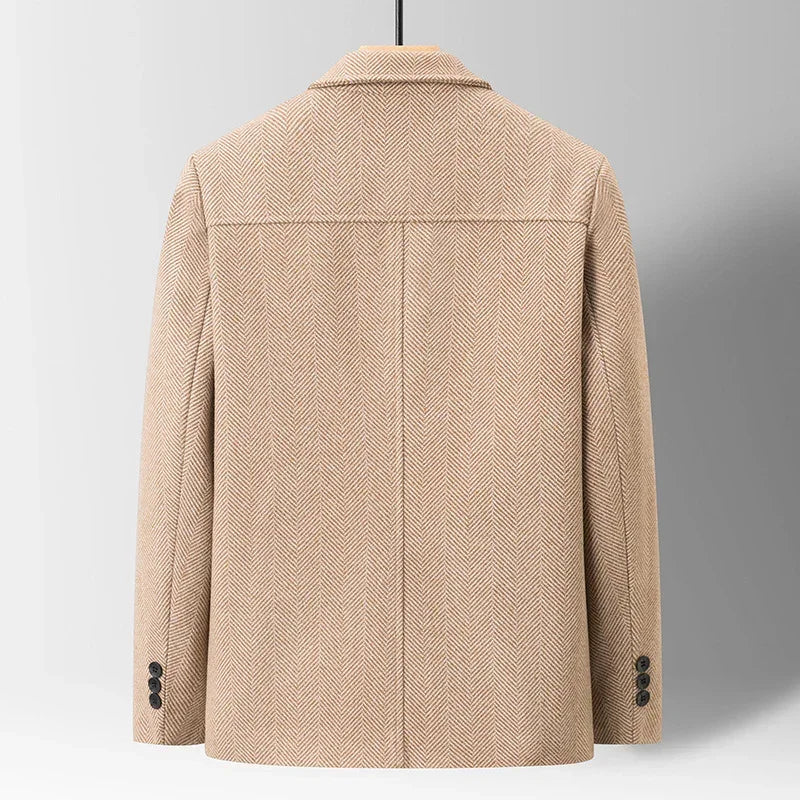 Back view of beige herringbone wool blazer with notch collar and buttoned cuffs, relaxed fit