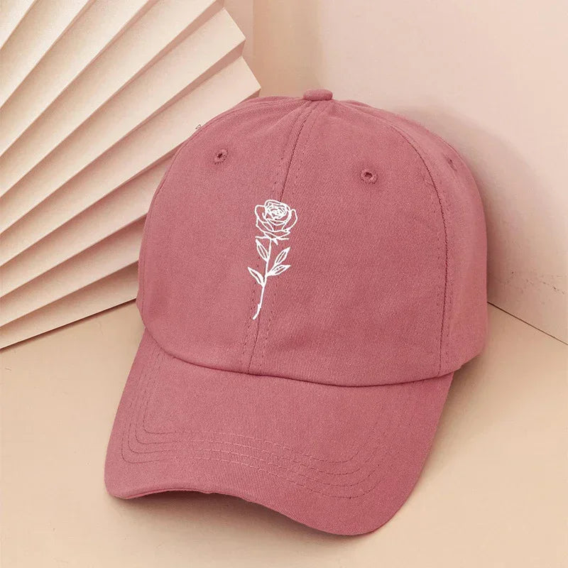 Pink cotton baseball cap with white rose embroidery, relaxed fit streetwear style