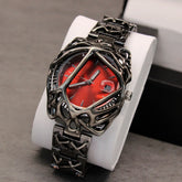 Futuristic metallic wristwatch with a red dial, skeletonized case, and chunky link band.