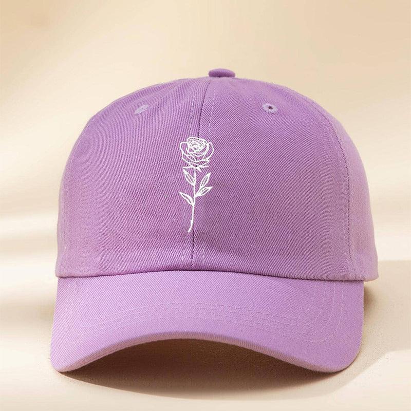 Purple cotton baseball cap with white rose embroidery, curved brim, relaxed fit