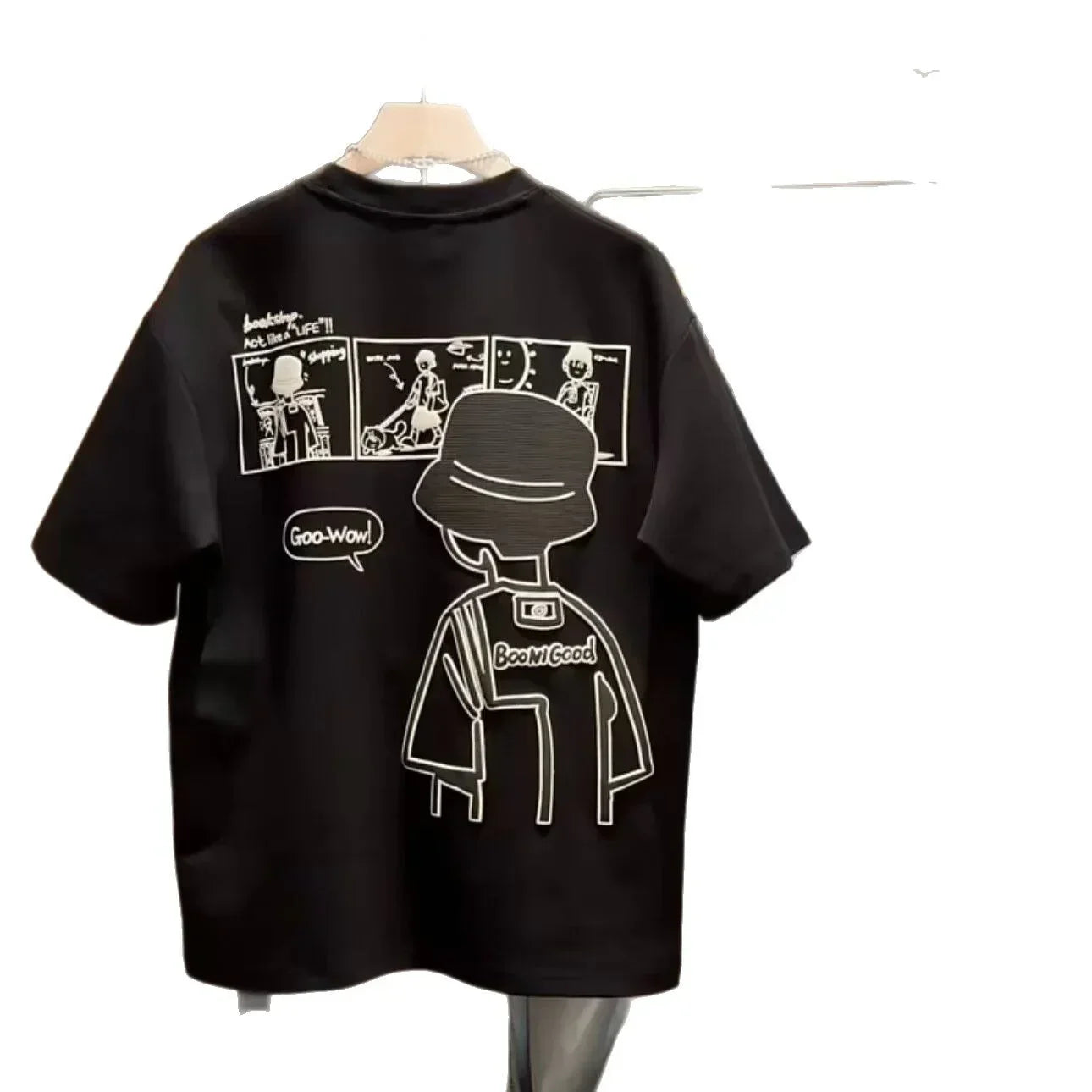 Black oversized t-shirt with white graphic cartoon print and comic strip on back, streetwear style.