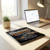 Modern minimalist office setup with a laptop, lamp, and potted succulent on a light wood desk; productivity-themed book and digital screen visible.