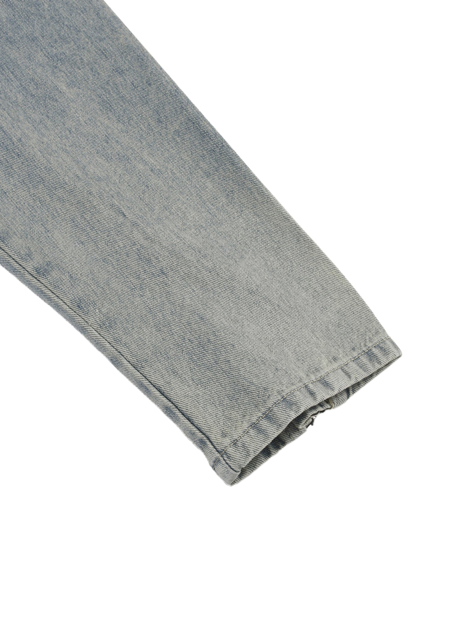Close-up of a folded denim fabric on a white background