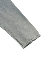 Close-up of a folded denim fabric on a white background