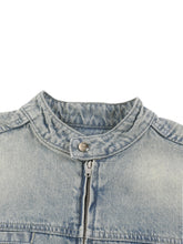 Close-up of a denim jacket collar with zipper on a white background