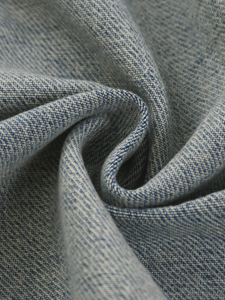 Close-up of textured blue fabric with a subtle pattern