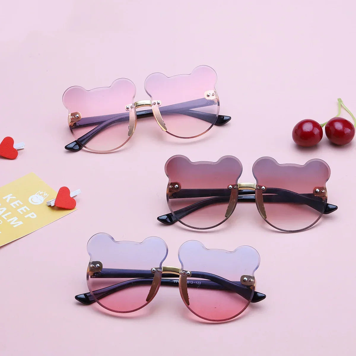Bear-shaped pink gradient sunglasses with gold frames, playful streetwear eyewear.