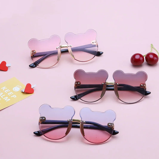 Bear-shaped pink gradient sunglasses with gold frames, playful streetwear eyewear.