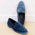 Blue velvet loafers with a slip-on design, low heel, and sleek modern fit