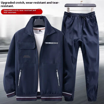 Navy blue windbreaker jacket and drawstring pants set, lightweight, relaxed fit, sporty style.