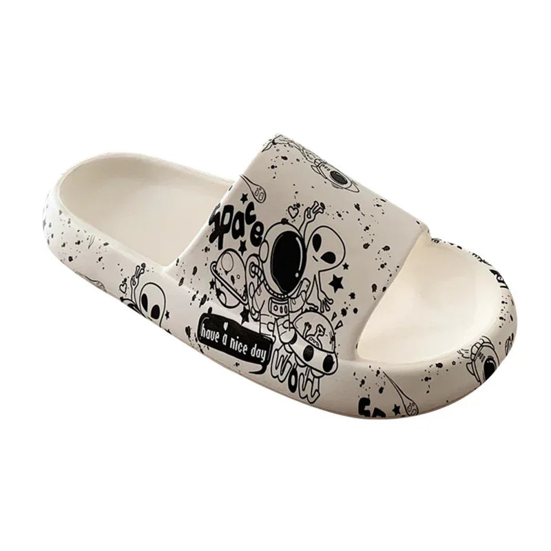 White slip-on sandal with black space-themed cartoon graphics, foam material, open toe design