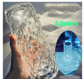 Clear geometric glass tumbler with textured diamond pattern, shown in hand and glowing under LED light, featured in five color options.