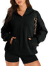 Woman wearing oversized black hoodie and black shorts, casual streetwear style