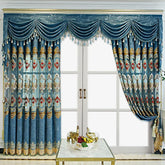 Luxurious blue curtains with gold and red embroidery, scalloped valance, and tassel details.
