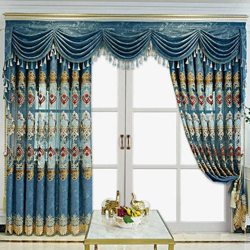 Luxurious blue curtains with gold and red embroidery, scalloped valance, and tassel details.