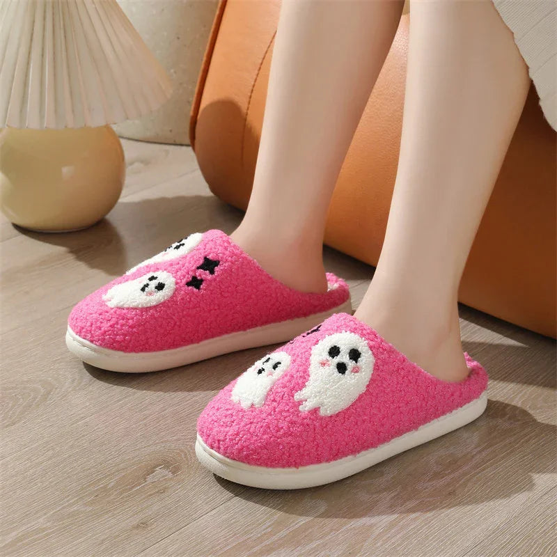 Pink fuzzy slippers with cute ghost applique, cozy fit, worn indoors on wood floor