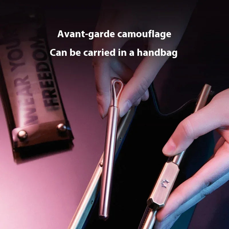 Metallic pen-style accessory in rose gold being placed into a sleek modern handbag