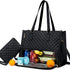Black quilted tote bag with insulated food compartment, carrying fruit and drinks.