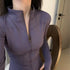 Fitted purple zip-up jacket with high collar, long sleeves, soft stretch fabric, modern style