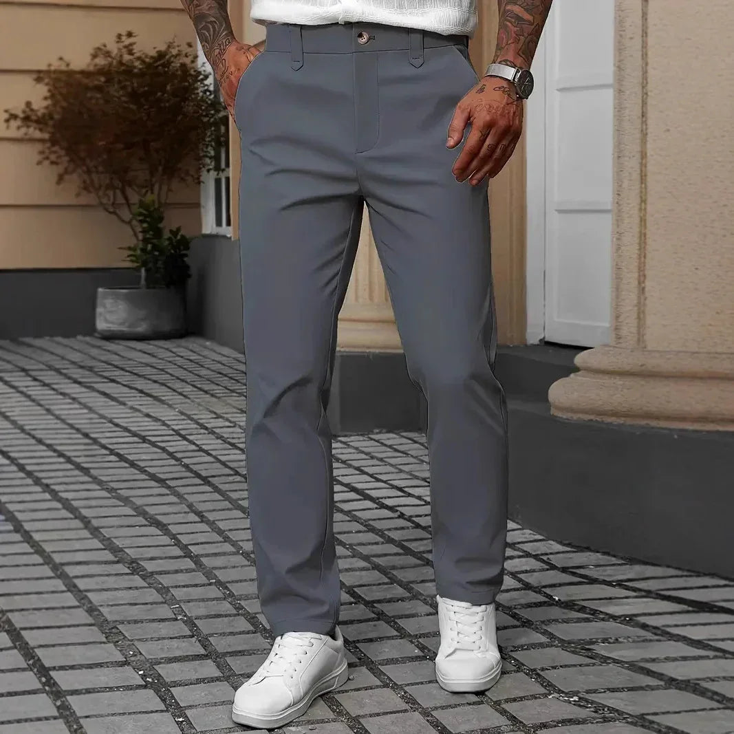 Slim fit gray casual pants with front pockets, paired with white sneakers