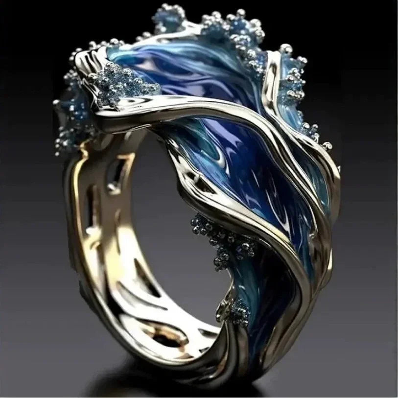 Metallic ring with swirling blue enamel, wave-inspired design, glossy finish, modern style