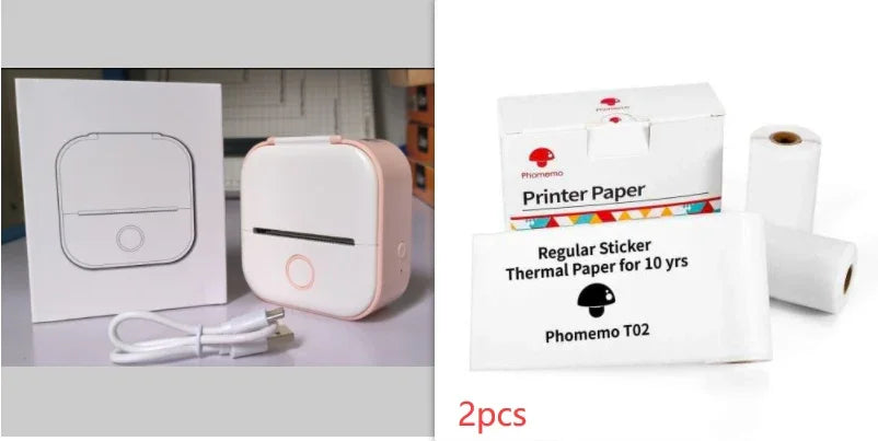 Compact white and pink portable thermal printer with charger and thermal paper rolls.